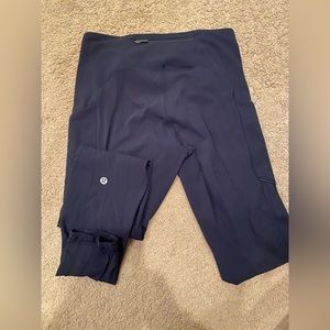 Navy full length Lululemon Leggings, with reflective pockets and back zipper